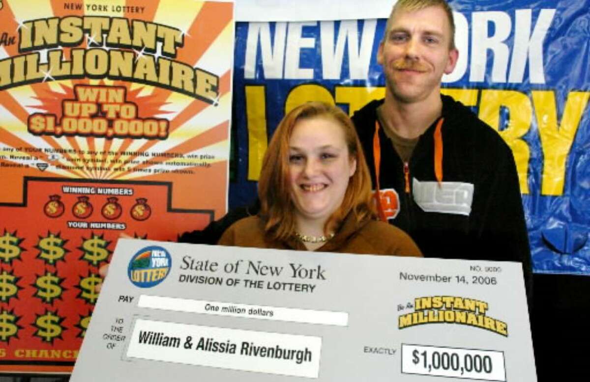 Scratch-off Lottery winners William Rivenburgh, right, and his wife, Lisa, right, pose Nov. 14, 2006 at a press conference announcing they'd won $1 million. (File photo)