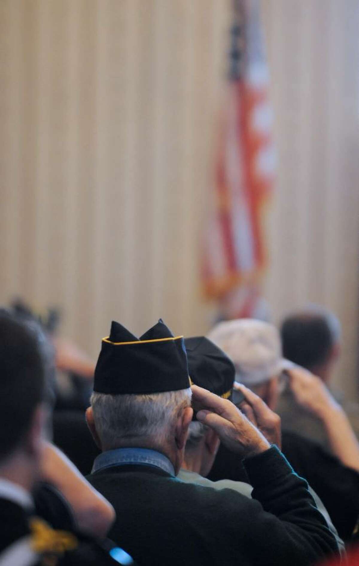 Veterans salute the colors at the Pearl Harbor Day memorial observance at the Joseph E. Zaloga Post American Post in Albany on Monday. (Skip Dickstein / Times Union)