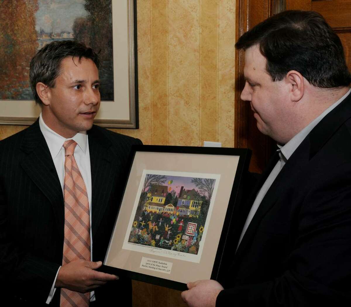 Paul Harding, left, of Martin, Harding and Mazotti law firm receives the first "Spirit of the House" award from Jeff Yule, executive director of the Ronald McDonald House in Albany on Jan. 8. (Skip Dickstein / Times Union)