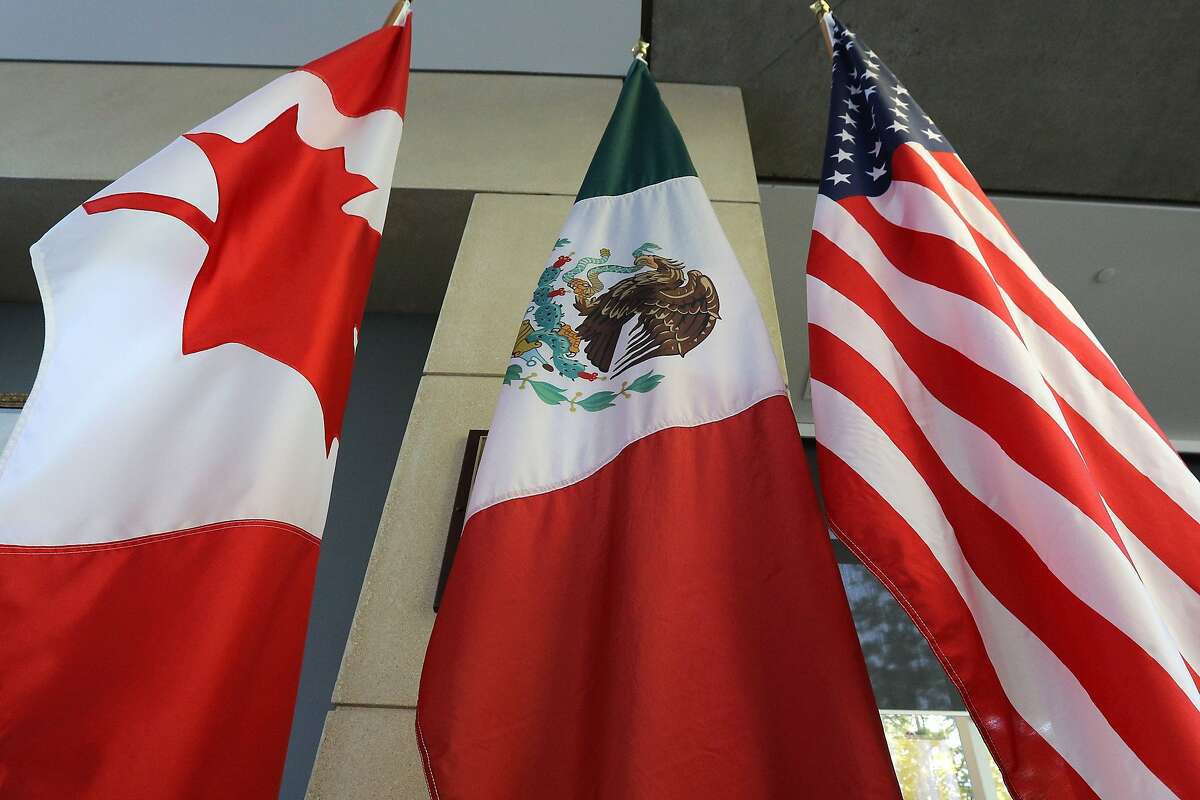 (FILES) This file photo taken on September 24, 2017 shows the Mexican, US and Canadian flags in the lobby where the third round of the NAFTA renegotiations took place in Ottawa, Ontario. Canada announced on January 23, 2018 it will sign on the Trans Pacific Partnership, moving to diversify its trade relationships as Canadian, US and Mexican negotiators kicked off a sixth round of talks on a 1994 free trade pact that Washington has threatened to dump. Canada had initially balked at joining the proposed TPP last year, acting as the main holdout in negotiations after US President Donald Trump decided in early 2017 to go it alone under his "America First" policy. / AFP PHOTO / Lars HagbergLARS HAGBERG/AFP/Getty Images