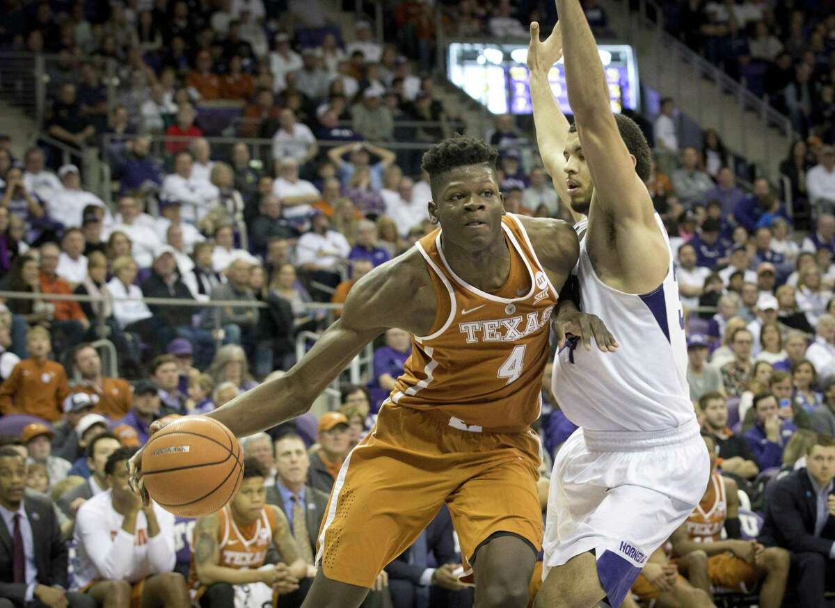 Texas's Mohamed Bamba (4) drives against TCU's Kenrich Williams in the Longhorns’ loss to the Horned Frogs Saturday.