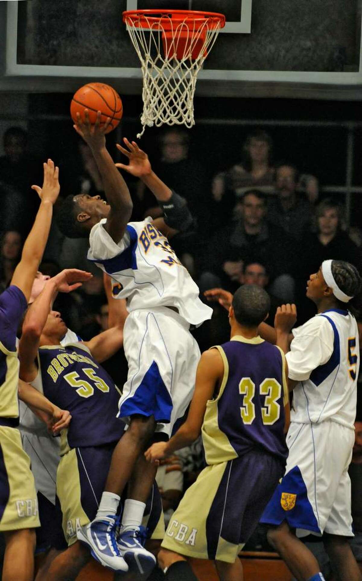 Bishop Maginn's Shaver Fields goes up for a basket against visting CBA. (Michael P. Farrell/Albany Times Union)