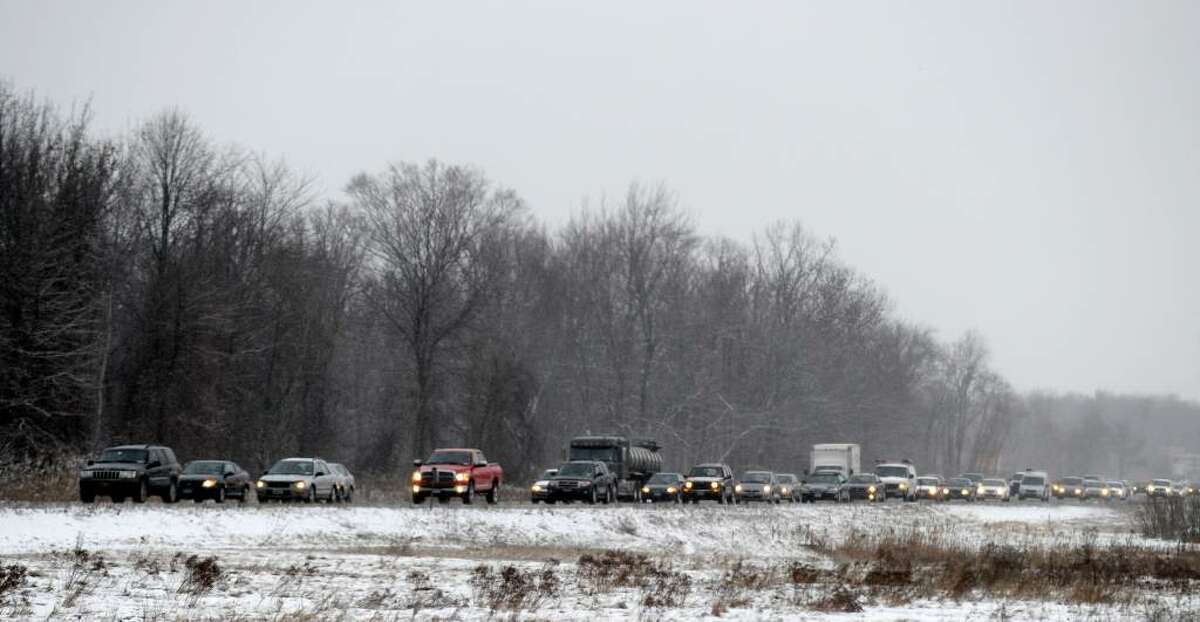 A light snow shower has slowed today's morning commute between southbound Exits 4 and 5 Interstate 87 in Colonie. (Skip Dickstein/ Times Union)