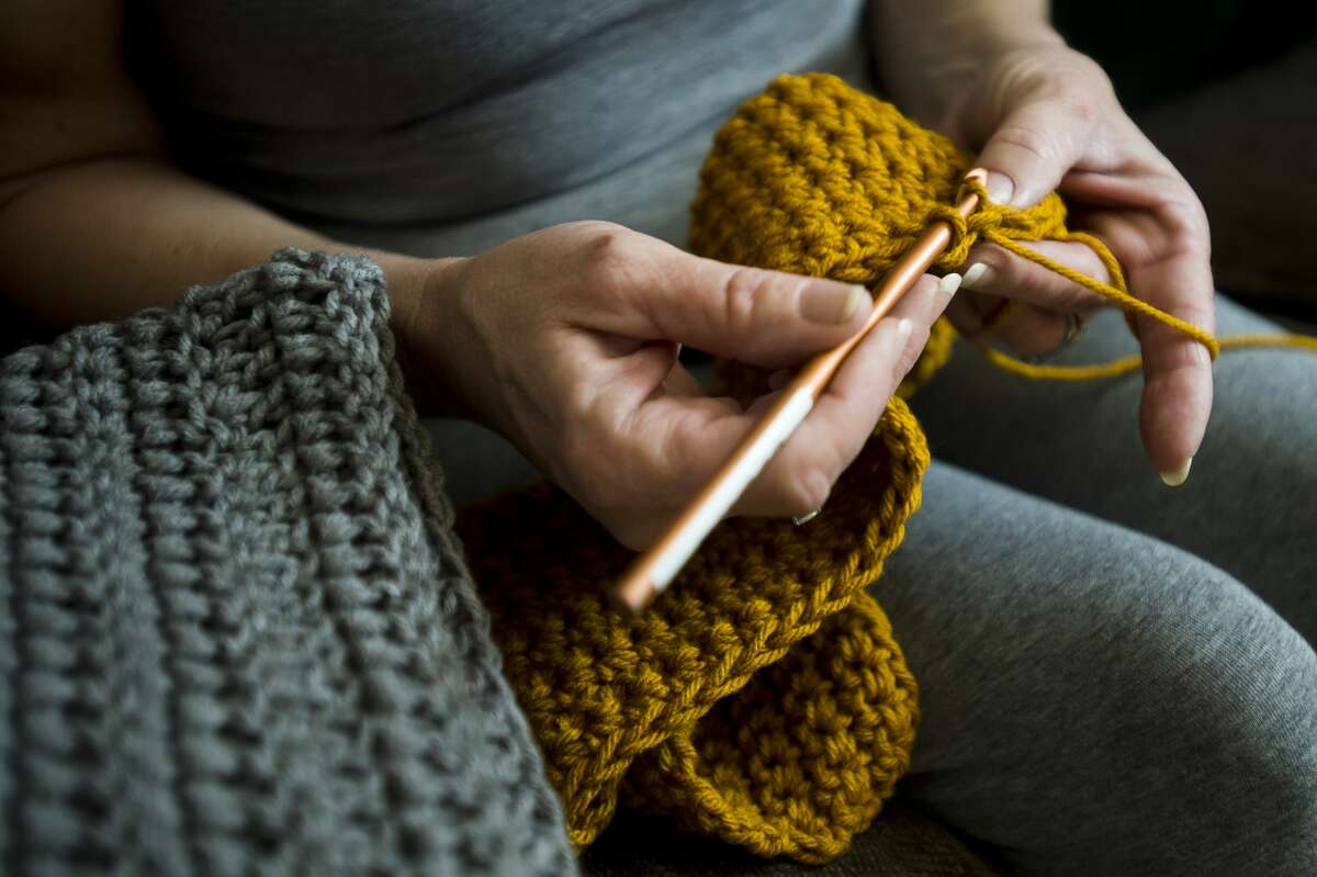 Debra Parady of Sanford works on one of many items she crochets for veterans inside her home on Monday, Feb. 12, 2018. (Katy Kildee/kkildee@mdn.net)