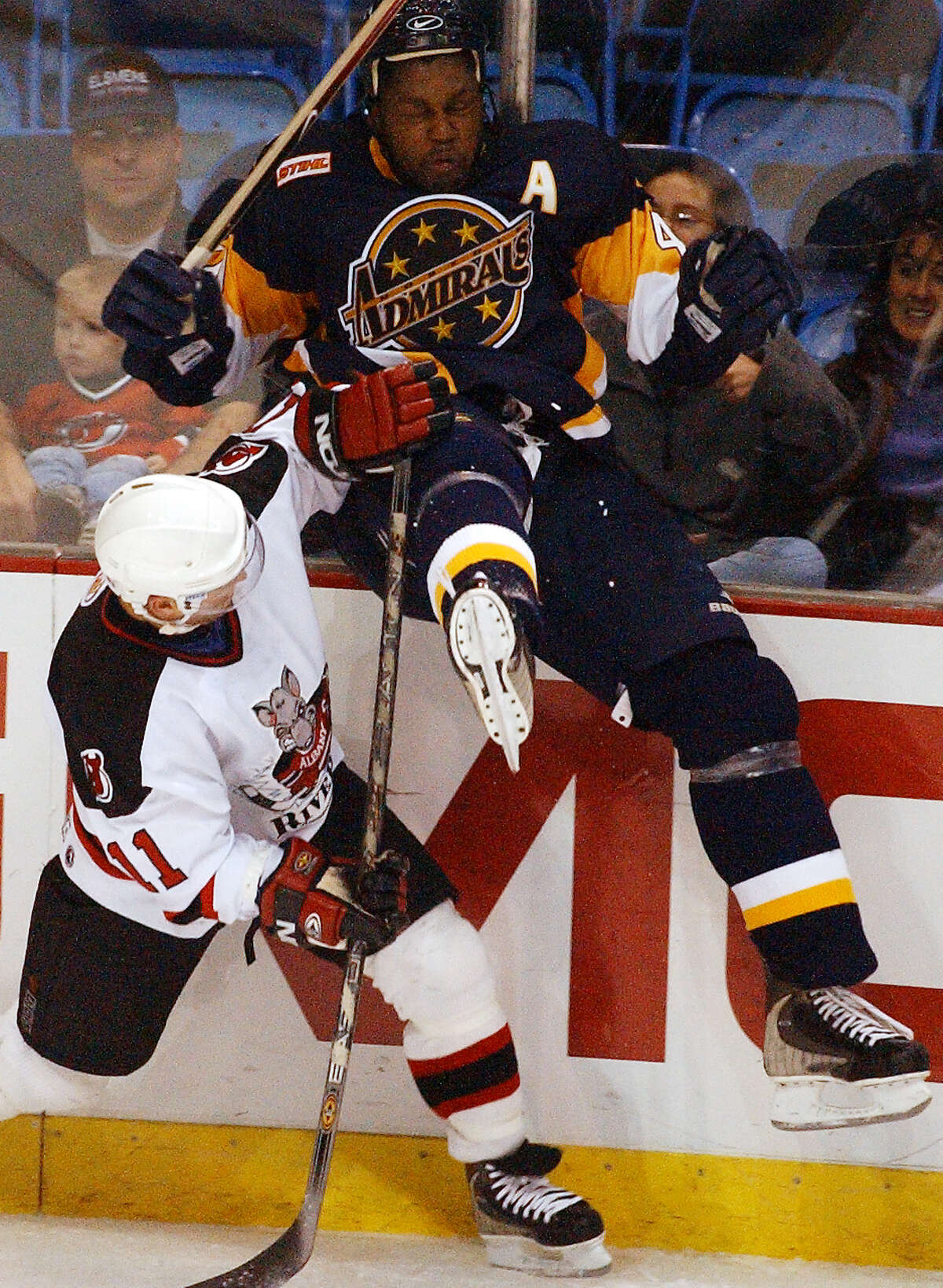 Times Union Photo by James Goolsby-Oct. 27, 2001-(L. to R.)-Albany River Rats #11-Brian Gionta launches Norfolk Admirals #40-Rumun Ndur in to the boards in the first half of game at the Pepsi Arena.