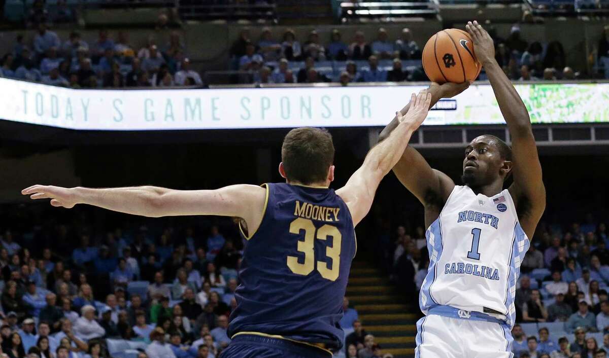 North Carolina's Theo Pinson (1) shoots while Notre Dame's John Mooney (33) defends during the first half of an NCAA college basketball game in Chapel Hill, N.C., Monday, Feb. 12, 2018. (AP Photo/Gerry Broome)