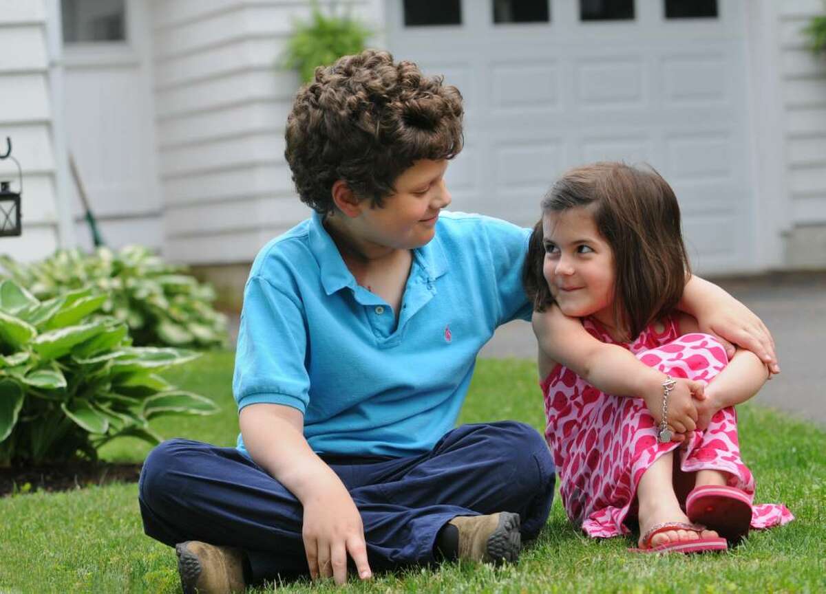 Ben Stowell and his neighbor Aiva Geracitano sit in front of her house in Latham on June 6, 2008. (Lori Van Buren / Times Union)
