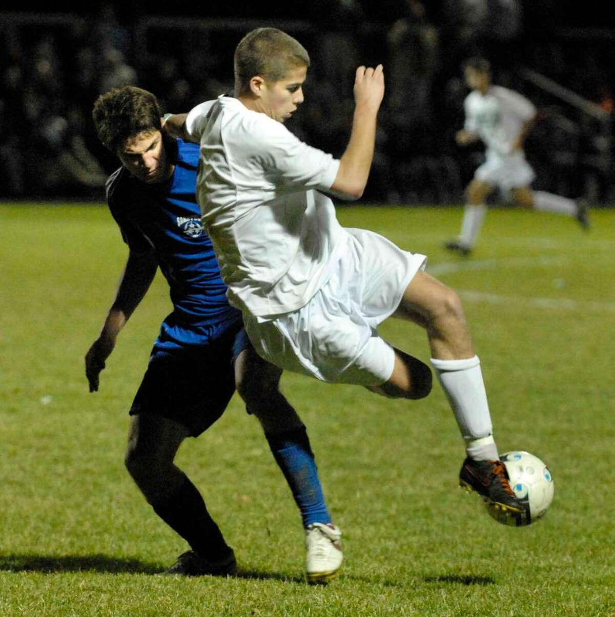 Shenendehowa's David Clemens, right, and Saratoga's Will Johns battle for the ball during their Section 2 Class AA Boys Soccer Championship game. Shenendehowa won 2-0. (Michael P. Farrell/Times Union)