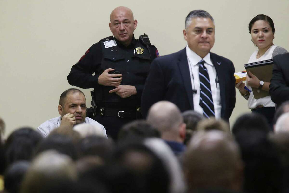 Mexican national Gustavo Tijerina-Sandoval, lower left, sits in front of the jury pool as jury selection begins in his capital murder trial in the Cameron County 197th District Court in Brownsville, Texas, Tuesday, Feb. 13, 2018. Tijerina-Sandoval is accused of killing U.S. Border Patrol agent Javier Vega, Jr. in August of 2014. Vega was fishing with his family in Santa Monica, a secluded area near Harlingen, when two men attempted to rob the group. Vega pulled out his weapon and was shot in the chest. He died en route to the hospital. Tijerina-Sandoval and Ismael Hernandez-Vallejo are both charged in Vega's death, but their trials will be held separately. One of his attorneys Nat Perez, Jr. stand next to him, second from right.