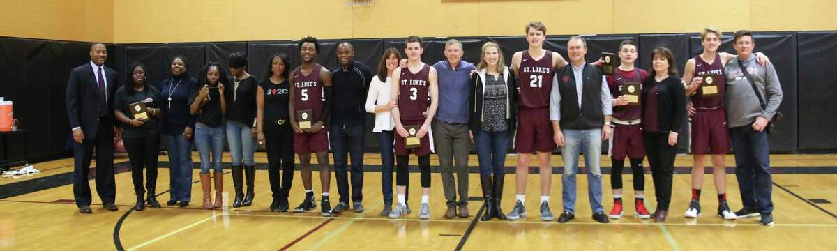 St. Luke's seniors pose with their parents after their Senior Day ceremony.