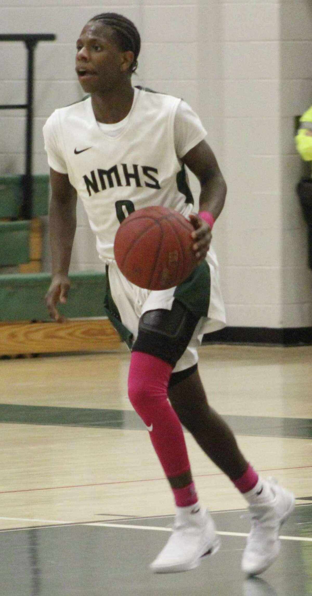 New Milford's Malik Proctor dribbles the ball up the court during the boys basketball game against Weston at new Milford High School Jan. 19, 2018.