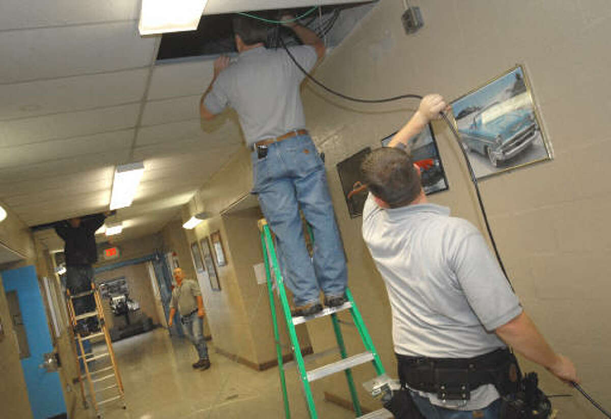 Time Warner crews upgrade cable wiring in preperation for President Barack Obama's visit to Hudson Valley Community College in Troy. (Michael P. Farrell / Times Union)