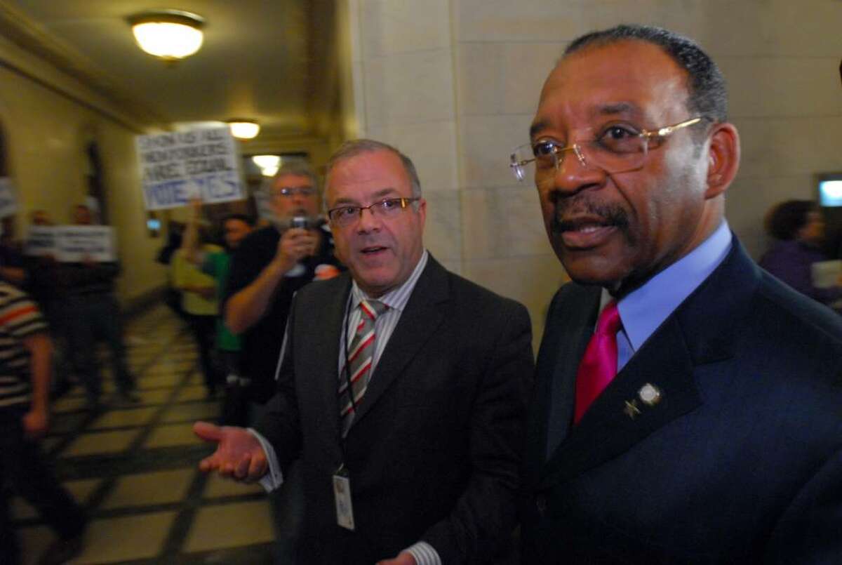 State Senator Ruben Diaz Sr., right, walks past gay marriage advocates, left, into a Democratic conference meeting at the Capitol in Albany, NY on Tuesday November 10, 2009. Diaz is against permitting a Senate vote on the issue. ( Philip Kamrass / Times Union)