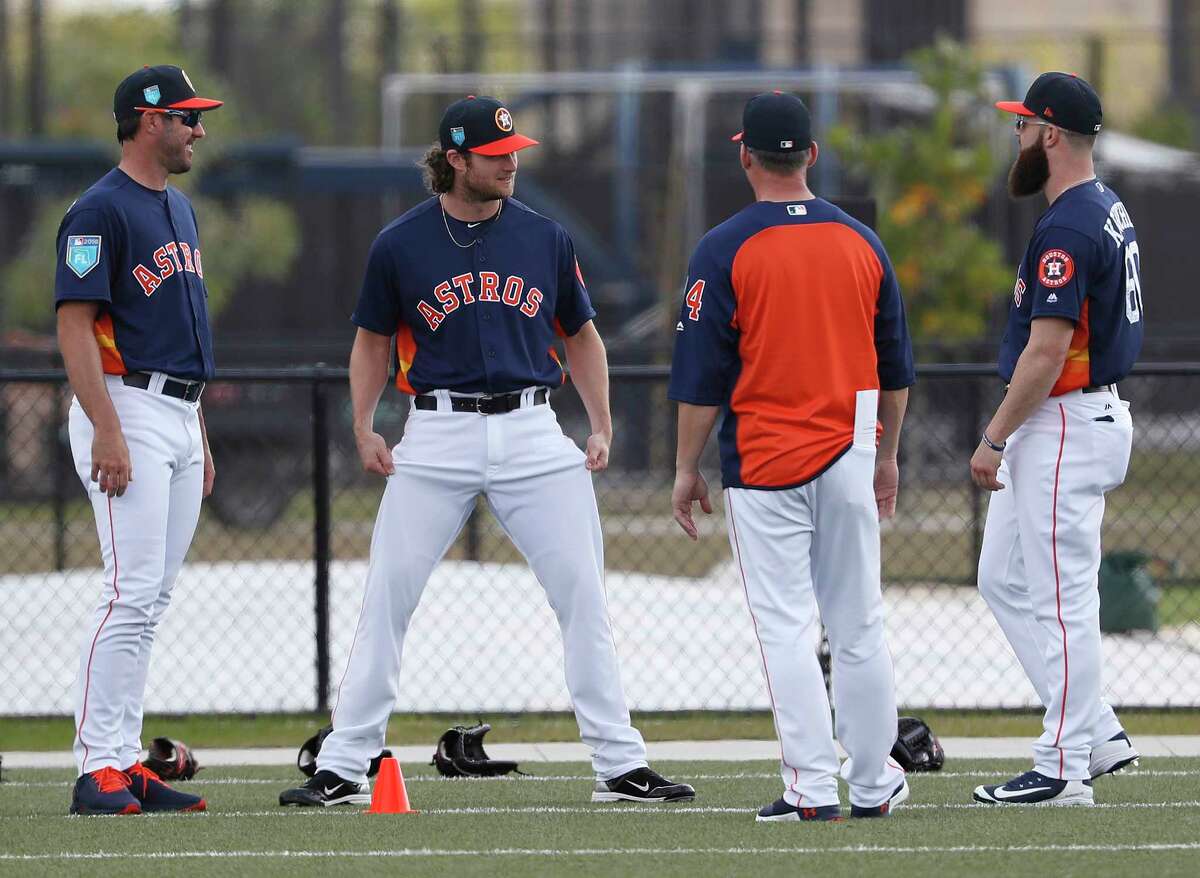 Houston Astros pitchers Justin Verlander (35), Gerrit Cole (45), and Dallas Keuchel (60) talk with manager A.J. Hinch during warmups as the pitchers and catchers worked out for the first time during spring training at The Ballpark of the Palm Beaches, Wednesday, Feb. 14, 2018, in West Palm Beach .