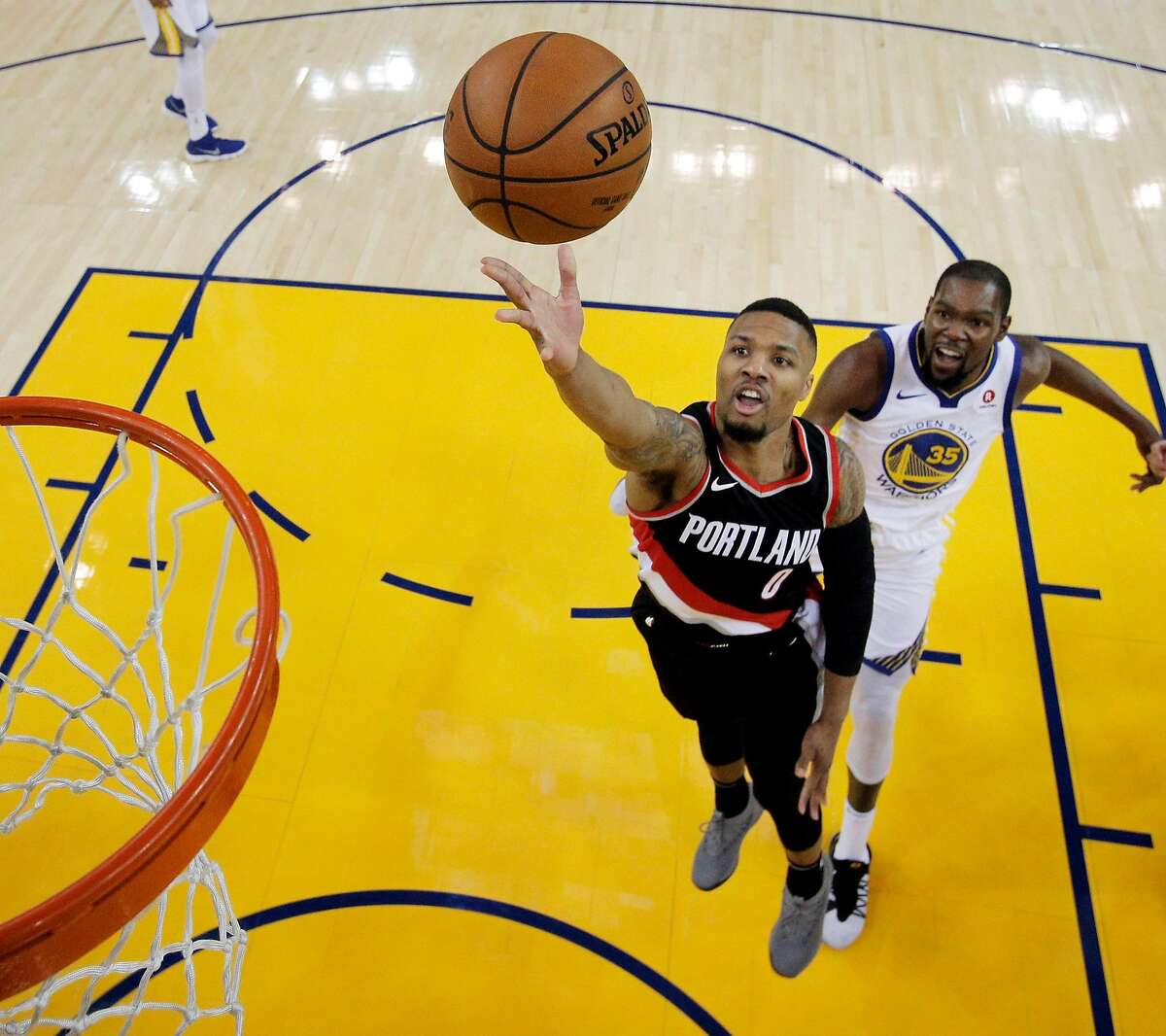 Damian Lillard (0) puts up a shot during the first half as the Golden State Warriors played the Portland Trail Blazers at Oracle Arena in Oakland, Calif., on Monday, December 11, 2017.