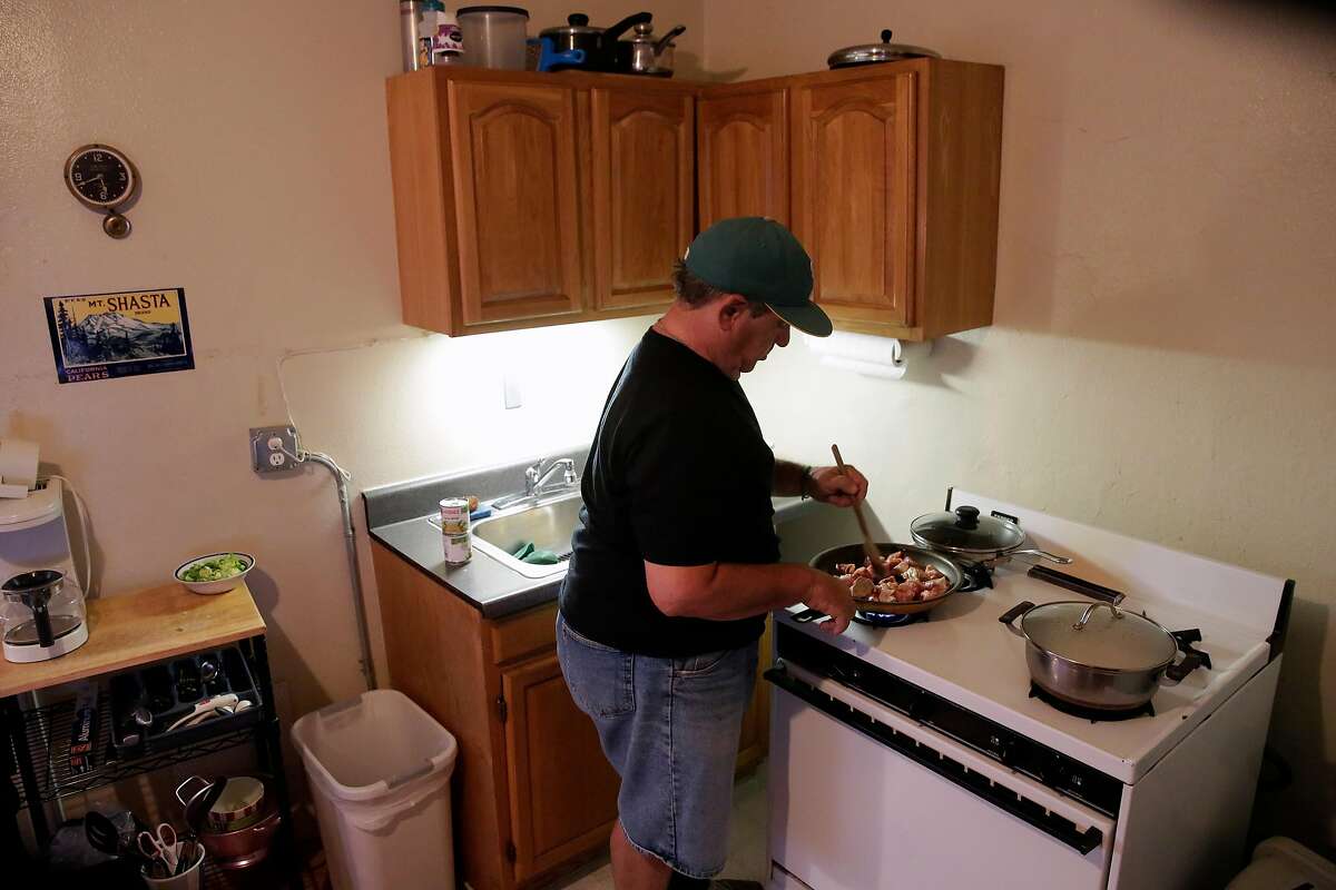 Steve Summers fixes his evening meal in his apartment in Oakland, Calif., seen on Tuesday Feb. 13, 2018. Summers relies on the benefits of the Federal governments Supplemental Nutritional Assistance Program, (food stamps) to buy fresh pork to make salsa verde as well as items from a local food pantry.