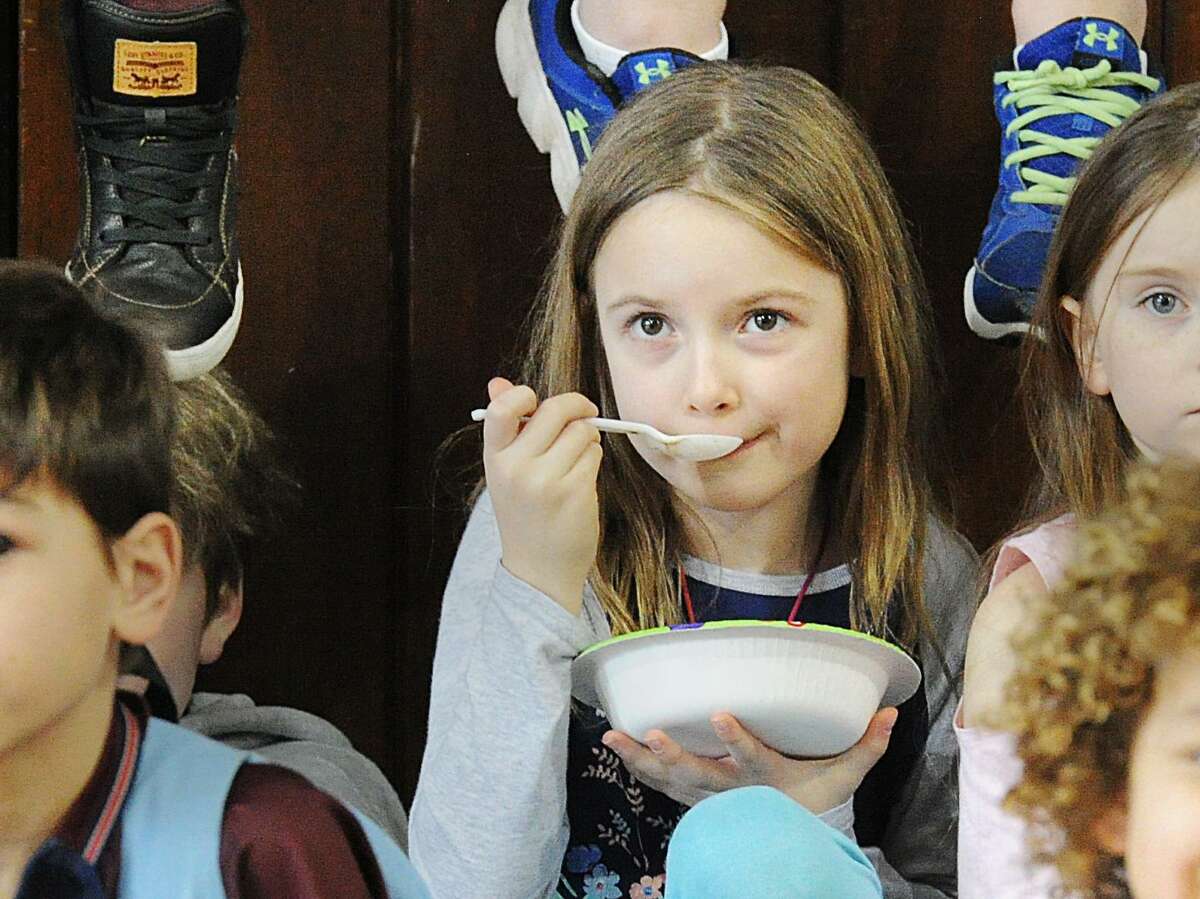 Boys & Girls Club of Greenwich Club member Charlotte Steidl, 7, enjoys a bowl of ice cream during the annual Ice Cream Social at the Boys & Girls Club of Greenwich at the club in Greenwich, Conn., Wednesday, Feb. 14, 2018. Rebecca Breed, a long time board member at the club has provided the ice cream and trappings for the event for the past 10 years in honor of St. Valentine's Day. Takeia McAllister the public relations director for the club said 175 club members were served ice cream during the event.