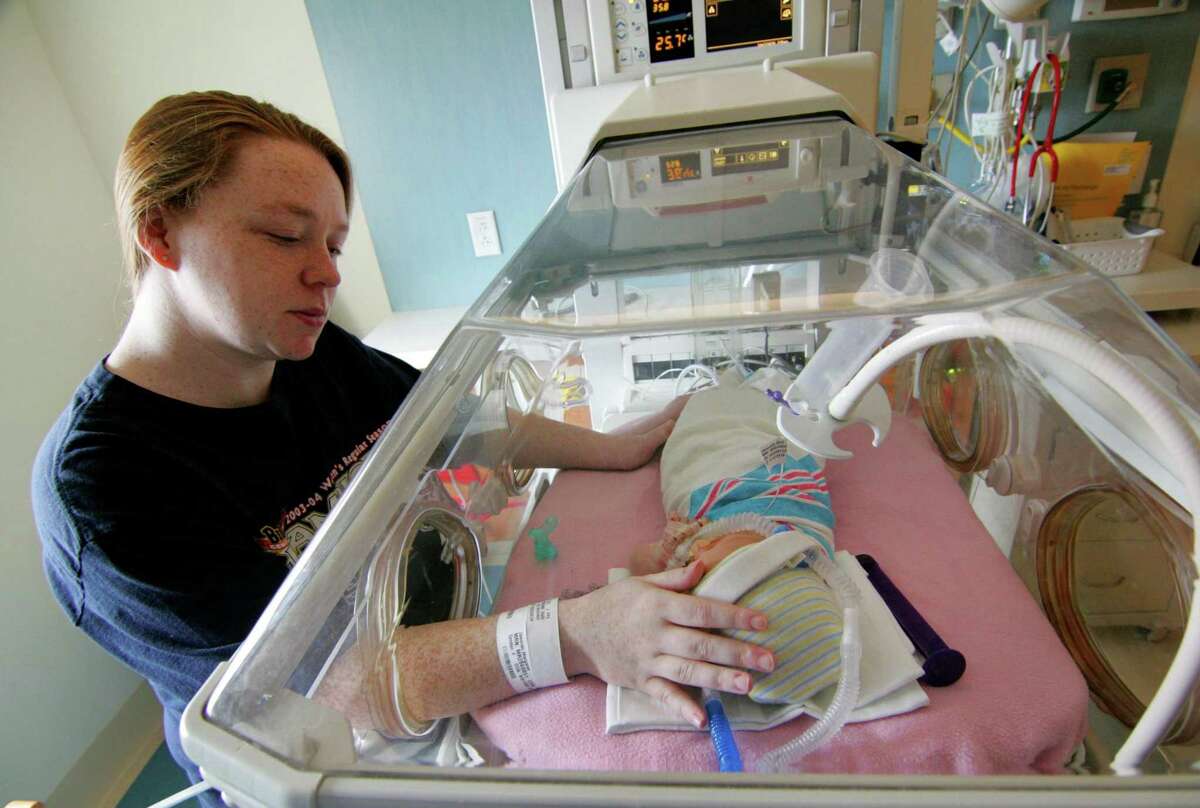 Margaret Jaworski, of Bridgeport, touches her baby who was born two days earlier at the new Allison Family Neonatal ICU at the Bridgeport Hospital campus of Yale New Haven Children’s Hospital Wednesday.
