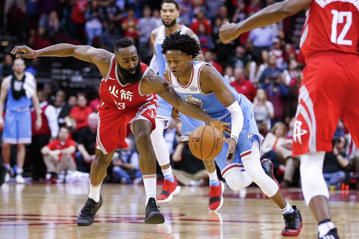 Houston Rockets guard James Harden (13) attempts to take the ball away from Sacramento Kings guard De'Aaron Fox (5) as the Houston Rockets beat the Sacramento Kings 100-91 at the Toyota Center Wednesday, Feb. 14, 2018 in Houston.