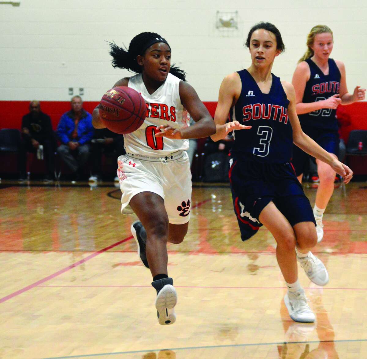 Edwardsville sophomore point guard Quierra Love, left, races up the court during a game against Parkway South.