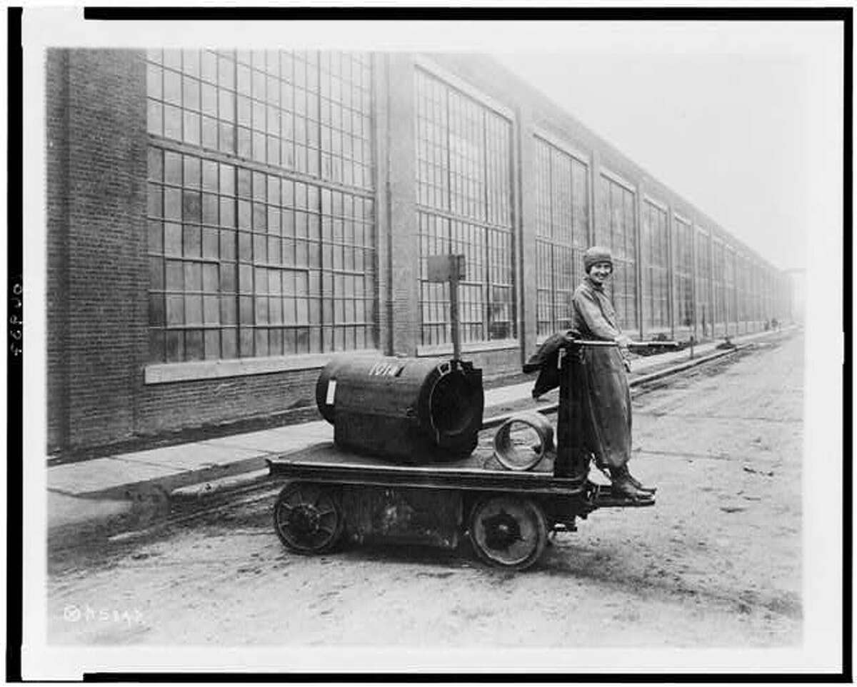 A woman stands on an electric shop truck at  Watervliet Arsenal during World War I. This photo was taken between 1914 and 1918.