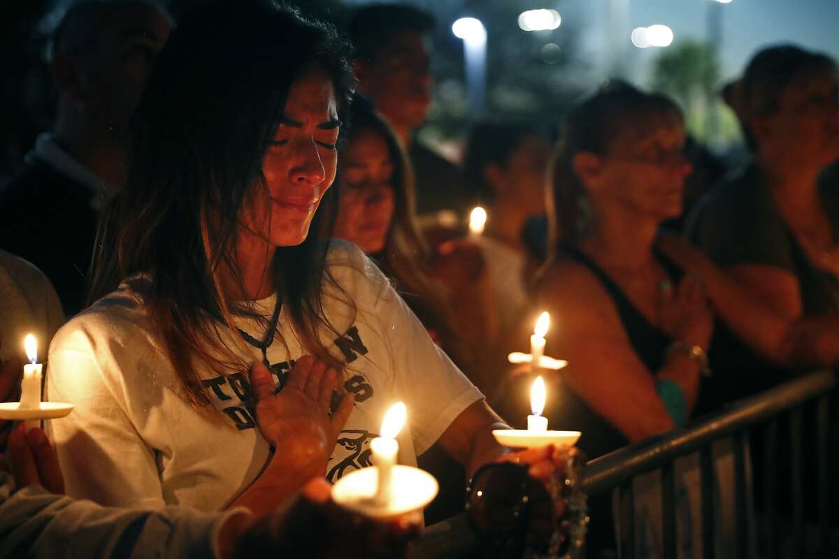 Lavinia Zapata, whose son is a student at Marjory Stoneman Douglas High School, cries during a candlelight vigil for the victims of the shooting. Three of the nation’s worst mass shootings have occurred in Trump’s year-old presidency.