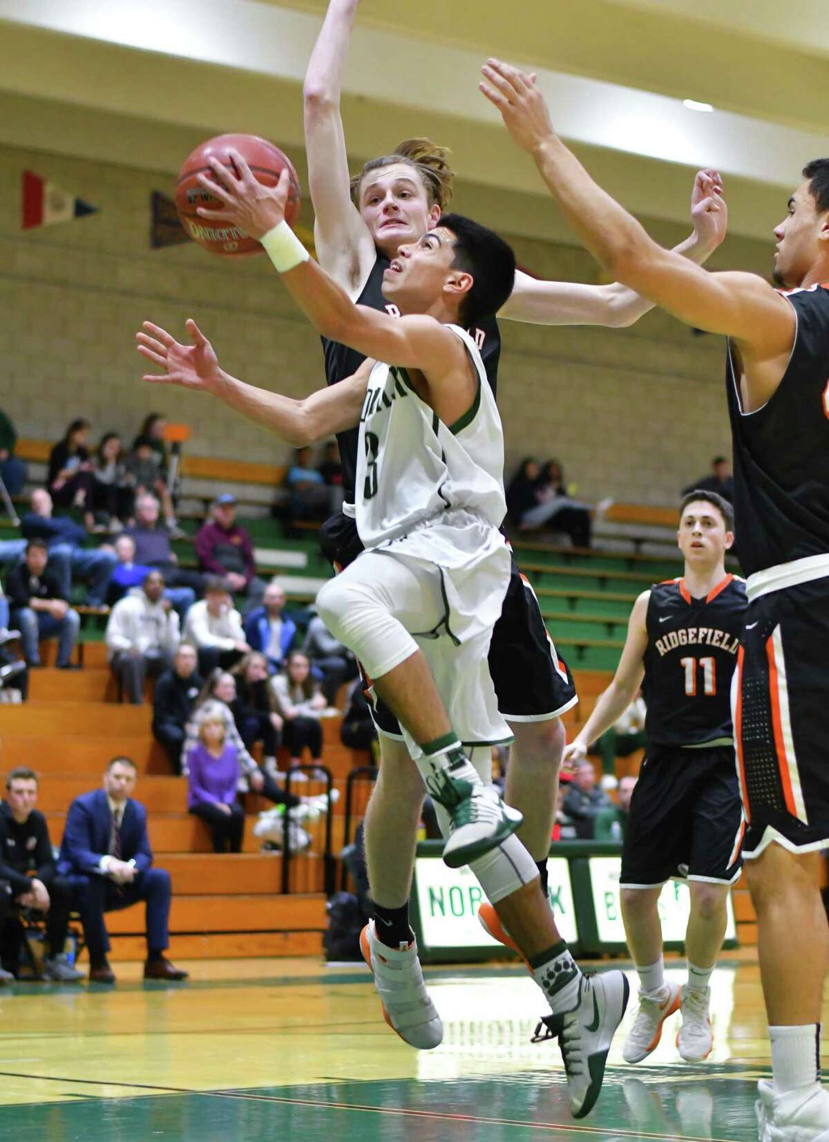 Norwalk’s Izaiah Lopez drives to the basket during Thursday’s game against Ridgefield at Norwalk High School.
