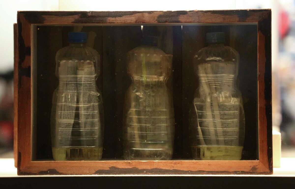 Bottles of pages of the Bible in oil are part of The Message in at Bottle exhibition at the Houston Museum of Natural Science on Wednesday, Feb. 14, 2018, in Houston. Chad Pregracke, the Living Lands & Waters crew and volunteers found bottles that contain messages since 1998 while cleaning up Mississippi River, Missouri River, Illinois River and Ohio River. ( Yi-Chin Lee / Houston Chronicle )