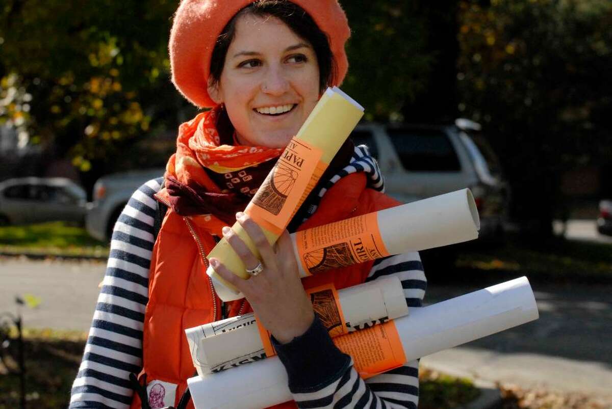 Sina Hickey part of PaperGirl, a performance art/guerrilla art project in which they and others ride bikes and hand out rolled-up original art on the streets of Albany, organize at Washington Park. (Michael P. Farrell / Times Union )