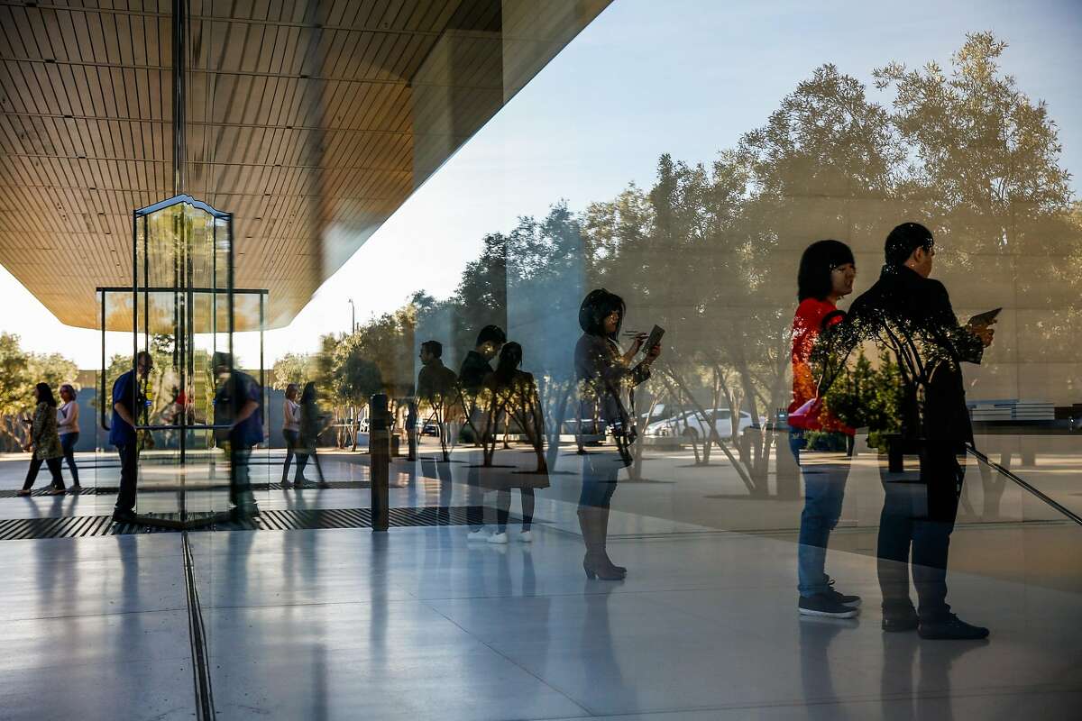 People explore the Apple visitors center in Cupertino, Calif., on Monday, Nov. 27, 2017.