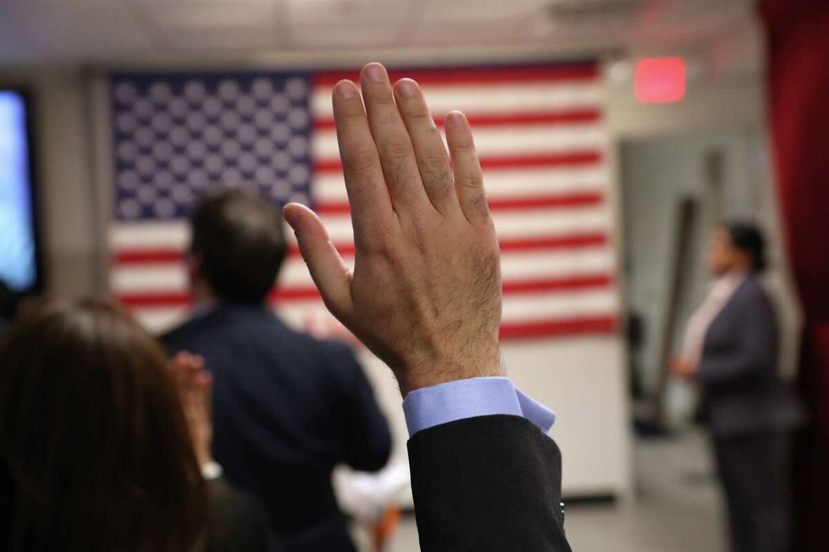 NEW YORK, NY - FEBRUARY 02: Immigrants take the oath of allegiance to the United States at a naturalization ceremony on February 2, 2018 in New York City. U.S. Citizenship and Immigration Services (USCIS) swore in 128 immigrants from 42 different countries during the ceremony at the downtown Manhattan Federal Building.