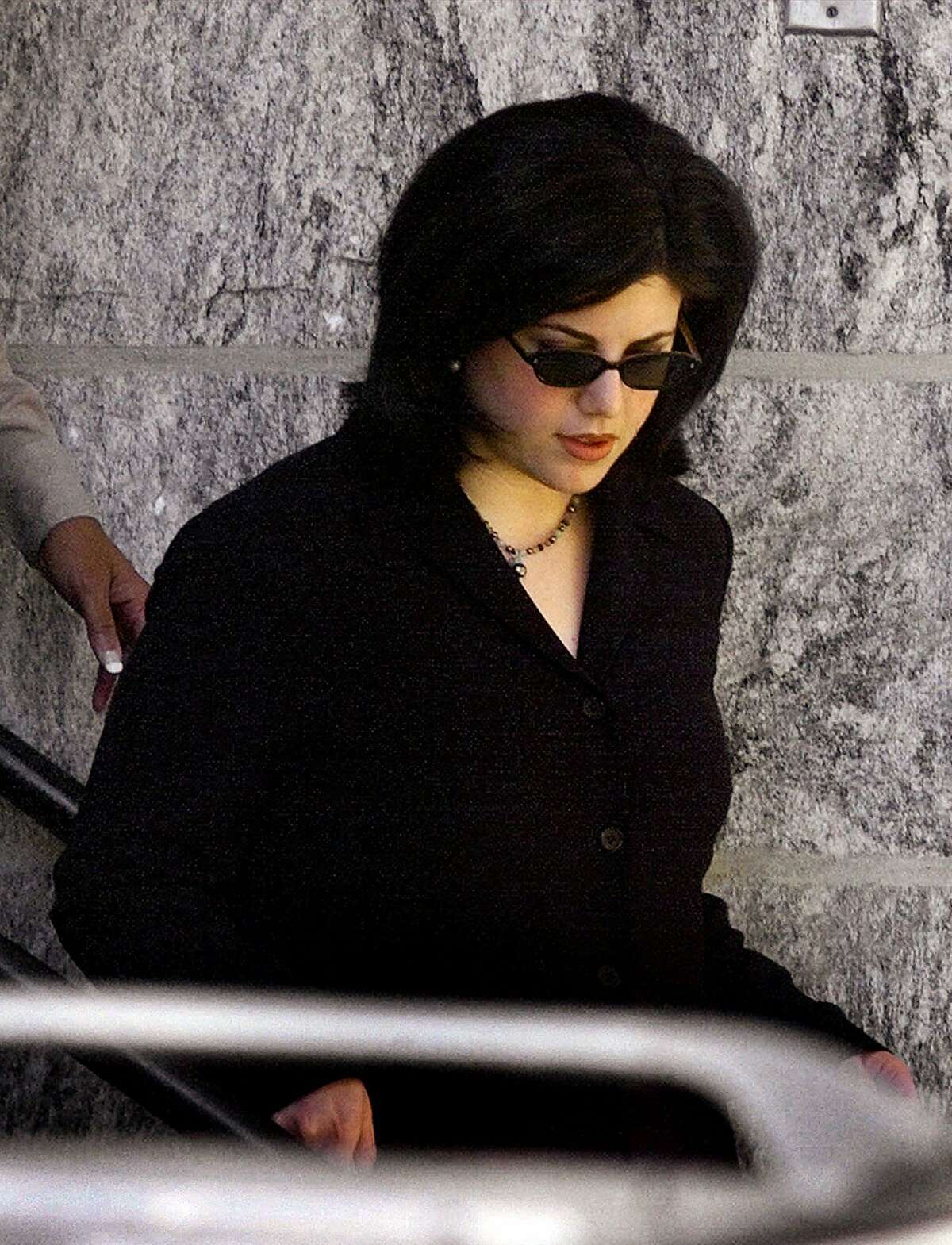 Monica Lewinsky leaves Howard County Circuit Court in Ellicott City, Md., Thursday, Dec. 16, 1999. Lewinsky testified that she was frightened when she saw the first published report of her secretly taped conversations with Linda Tripp about President Clinton. (AP Photo/Ron Edmonds)