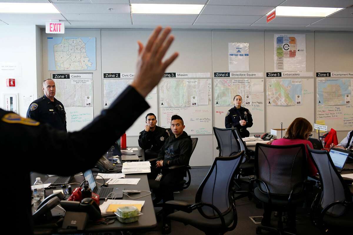 Commander David Lazar (hand at left) talks in a multi-department meeting at the San Francisco Department of Emergency Management in San Francisco, Calif., on Wednesday, February 14, 2018.