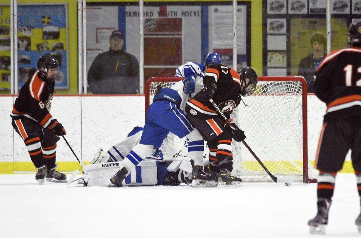 Ridgefield's Kieran McGowan (17) scores in the first period against Darien during an FCIAC Boys Ice Hockey game at Terry Conners Rink on Friday, Feb. 16, 2018 in Stamford, Connecticut. Ridgefield defeated Darien 5-3.