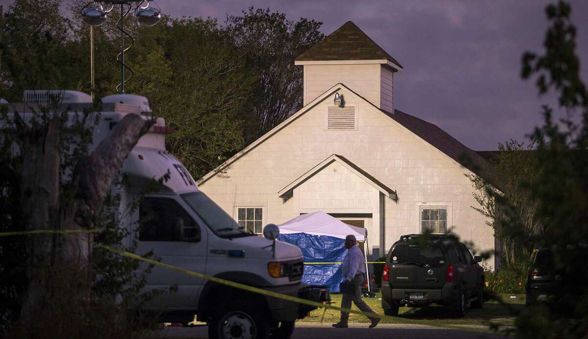 A man walks past the front of the First Baptist Church where a gunman opened fire on a Sunday service and killed at least 26 people in Sutherland Springs, Texas on Monday, Nov. 6, 2017. (Nick Wagner/Austin American-Statesman/TNS)