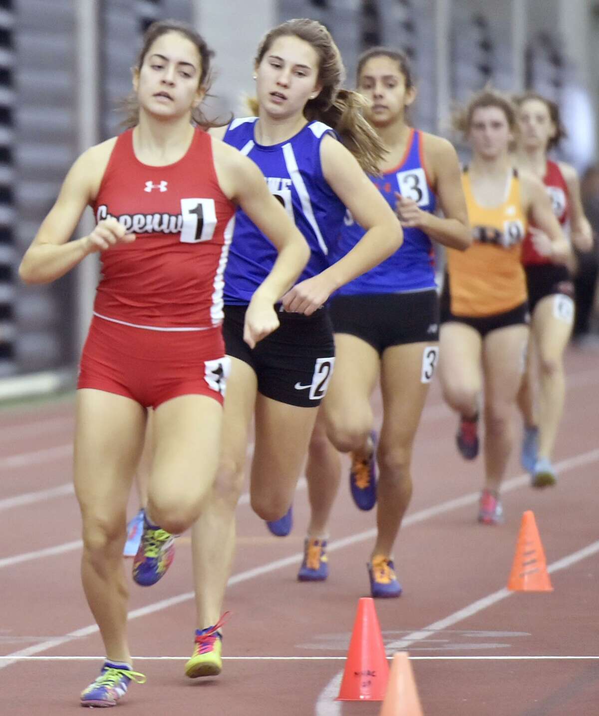 New Haven, Connecticut - Saturday, February 10, 2018: Girls 1000 meter run winner Emily Philippides of Greenwich H.S., left, runs ahead of eventual third place winner Alyssa Kraus of Fairfield-Ludlowe H.S. during the 2018 State Class LL Girls and Boys Indoor Track and Field Championship at the Floyd Little Athletic Center in New Haven .