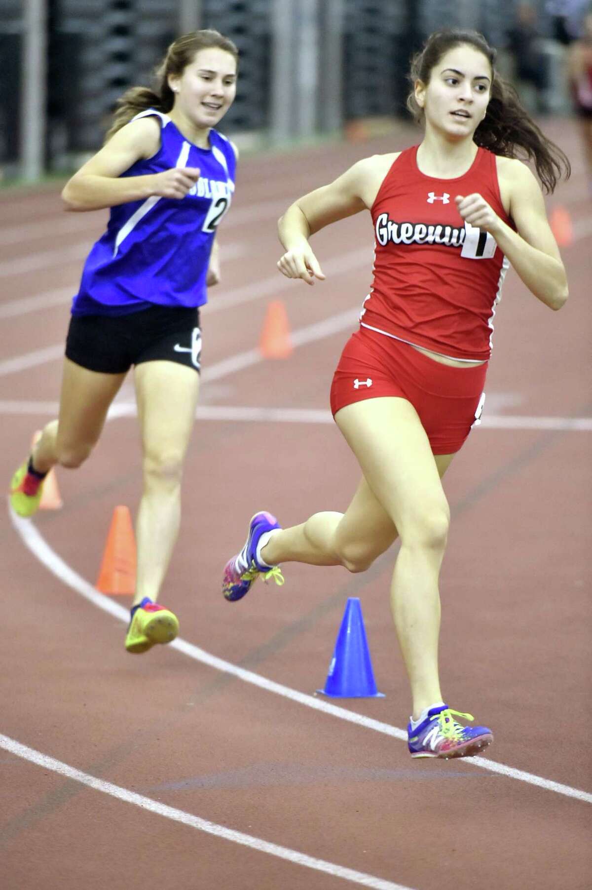 New Haven, Connecticut - Saturday, February 10, 2018: Girls 1000 meter run winner Emily Philippides of Greenwich H.S., right, runs ahead of eventual third place winner Alyssa Kraus of Fairfield-Ludlowe H.S. during the 2018 State Class LL Girls and Boys Indoor Track and Field Championship at the Floyd Little Athletic Center in New Haven .