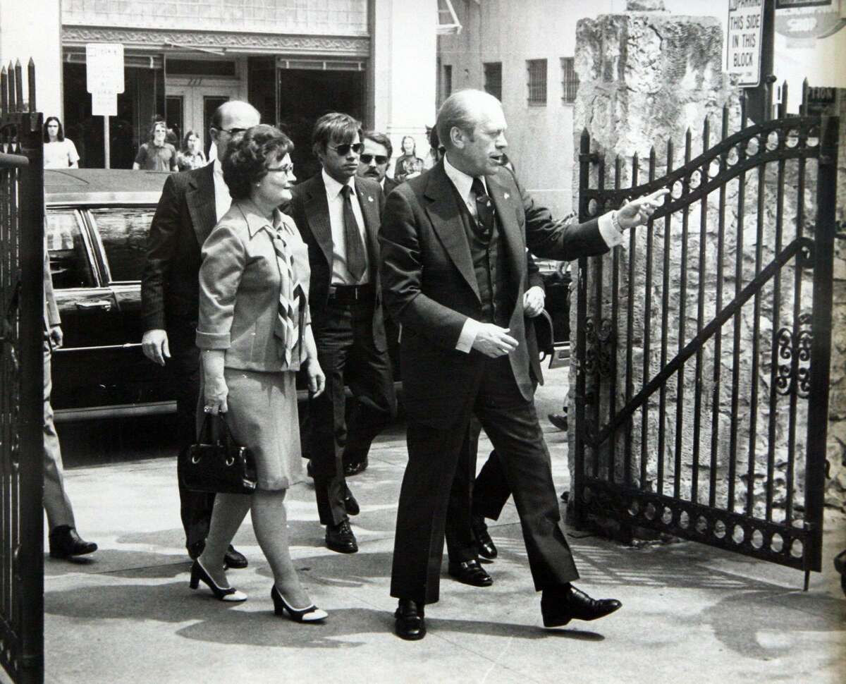 President Gerald Ford and San Antonio Mayor Lila Cockrell enter the grounds of the Alamo during his visit in 1976.