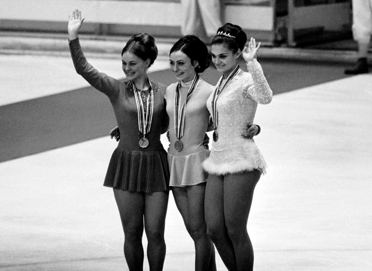 Women Olympic Skating Medalists on the podium after receiving their medals, at Grenoble, France, on Feb. 10 1968. From left to right: Gabriele Seyfert of France, who win silver, Peggy Fleming of the U.S.A. who won gold and Hana Maskova of Czechoslovakia who won bronze. (AP Photo)