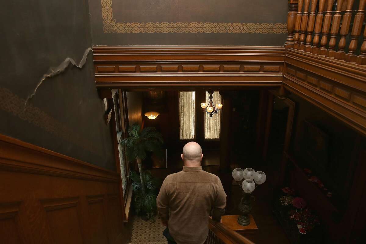 The great grandchild of William and Bertha Haas, John Rothmann walks down the stairway to the first floor where the crack on left is from the 1989 earthquake at the Haas Lilenthal house which has recently been restored on Thursday, February 15, 2018, in San Francisco, Ca.