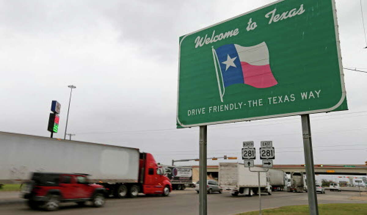 Commercial and passenger vehicles pass the Welcome to Texas sign near the Pharr International Bridge.
