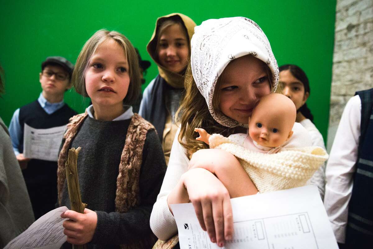 Julie Kruyt and Sofia Meis wait to be called during the Ellis Island Simulation at the Whitby School in Greenwich, Conn. on Thursday, February 8, 2018. During the simulation, students were assigned roles as immigrants from different countries with different financial and wellness backgrounds, while teachers acted as immgration and deportation officers, as well as nurses, to determine if the students were eligible to gain entry to the United States.