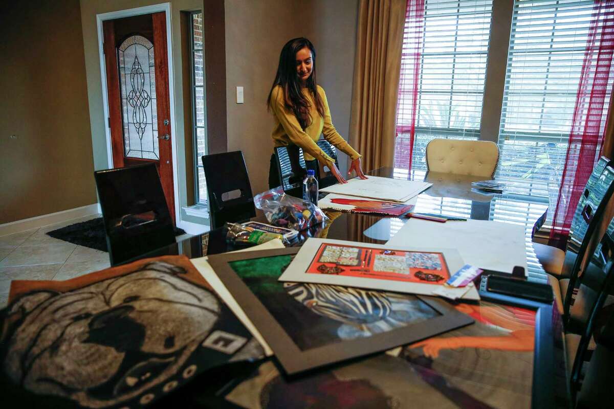 University of Houston senior Anmol Momin looks through some of her artwork Tuesday, Feb. 13, 2018 in Richmond. Momin has entered one piece, Soul Browser, in the Southwest Jubilee Arts Festival. The festival, which promotes and showcases the work of aspiring Ismaili Muslim artists, will take place at the Marriott Marquis Houston Feb. 24-25. (Michael Ciaglo / Houston Chronicle)