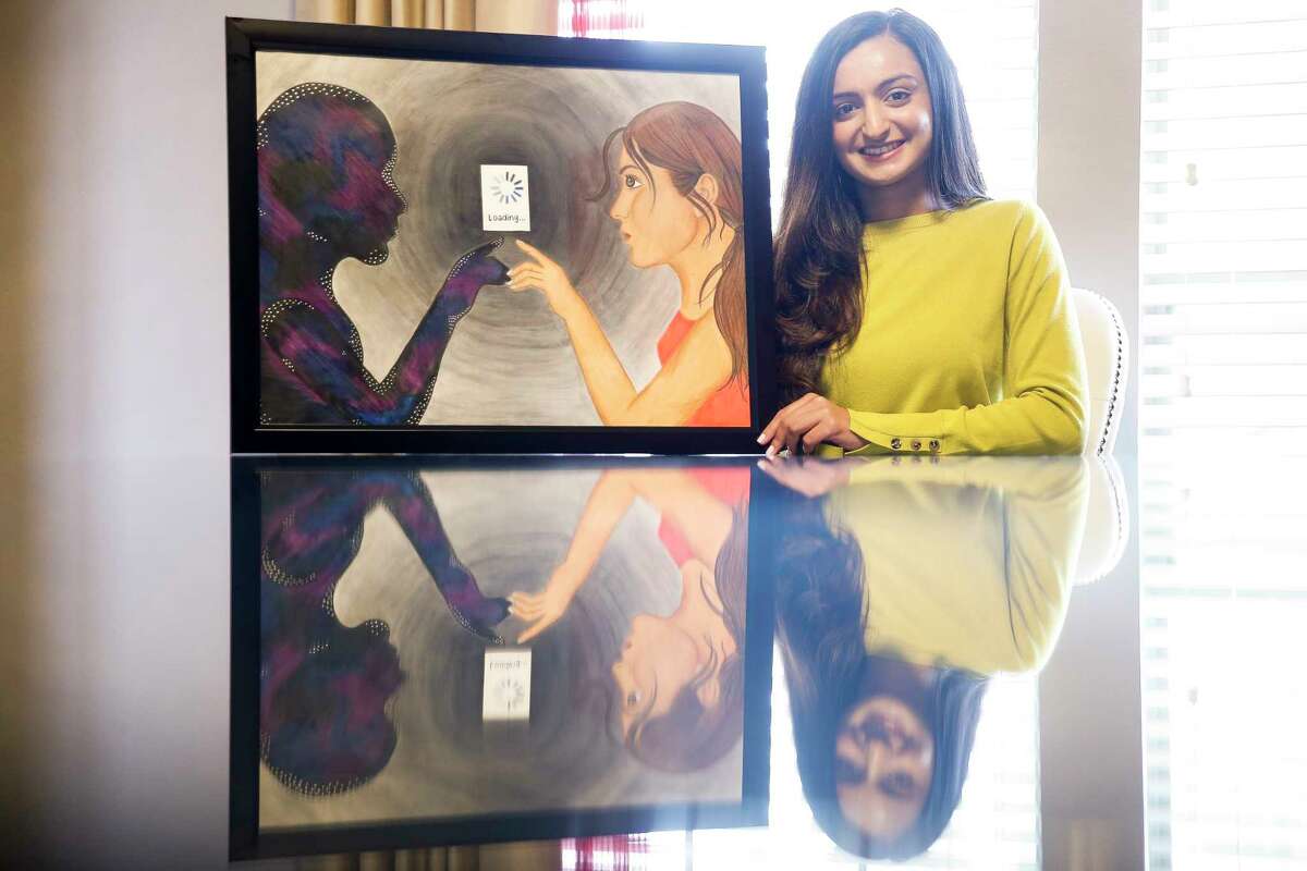 University of Houston senior Anmol Momin sits with her colored pencil art work, Soul Browser, Tuesday, Feb. 13, 2018 in Richmond, which she has entered in the Southwest Jubilee Arts Festival. The festival, which promotes and showcases the work of aspiring Ismaili Muslim artists, will take place at the Marriott Marquis Houston Feb. 24-25. (Michael Ciaglo / Houston Chronicle)