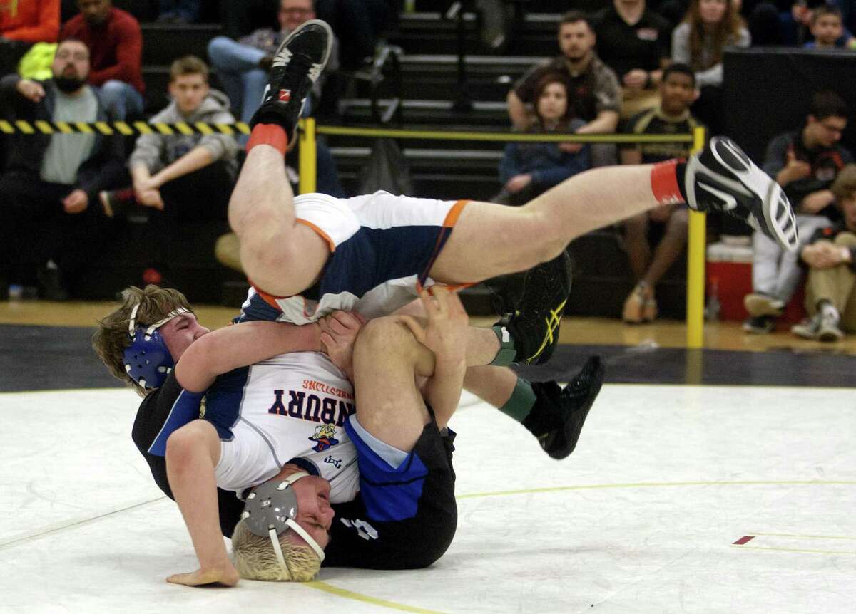 Danbury's Gino Baratta is turned over by Southington's Paul Calo during Class LL Wrestling Championship action in Trumbull, Conn. on Saturday Feb. 17, 2018.