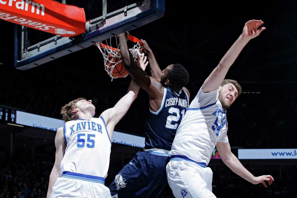 CINCINNATI, OH - FEBRUARY 17: Dhamir Cosby-Roundtree #21 of the Villanova Wildcats dunks against J.P. Macura #55 and Sean O'Mara #54 of the Xavier Musketeers in the second half of a game at Cintas Center on February 17, 2018 in Cincinnati, Ohio. Villanova won 95-79. (Photo by Joe Robbins/Getty Images)
