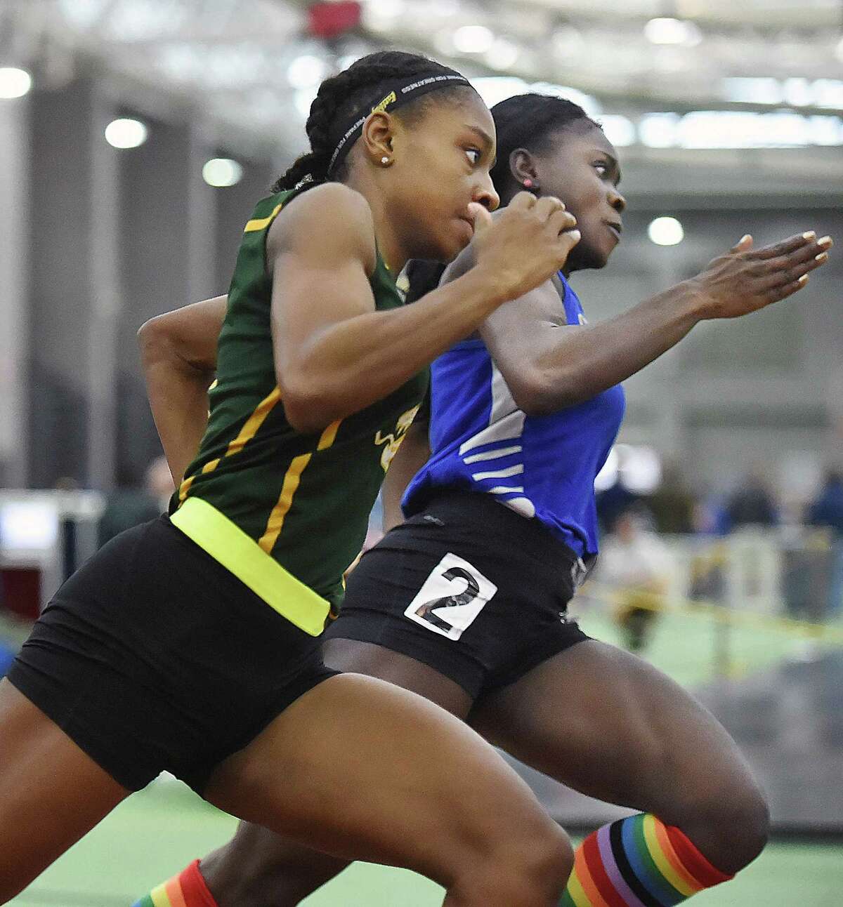 Hamden’s Aisha Gay, left, finished first in the 300 meters at the girls indoor track and field State Open Saturday in New Haven.