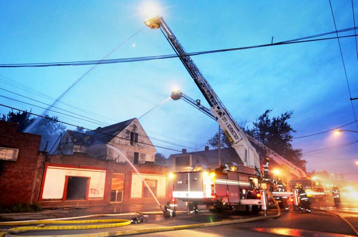 A stubborn blaze destroyed multiple buildings in the area of 954 State St. in Schenectady on Monday. Firefighters worked for hours to control the fire, which occurred adjacent to a flea market that caught fire a few weeks ago. (Luanne M. Ferris / Times Union)