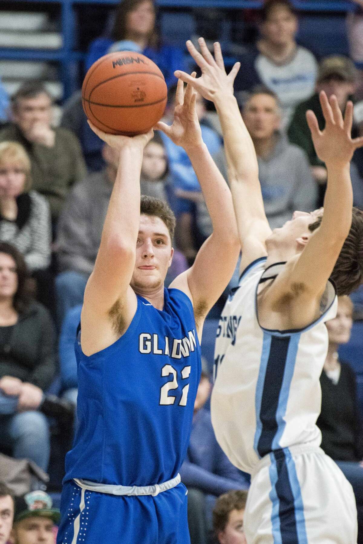 Gladwin senior Max Wentworth takes a shot as Meridian senior Hunter Wishowski tries to block him during a basketball game at Meridian High School in Sanford on Friday. (Danielle McGrew Tenbusch/for the Daily News)
