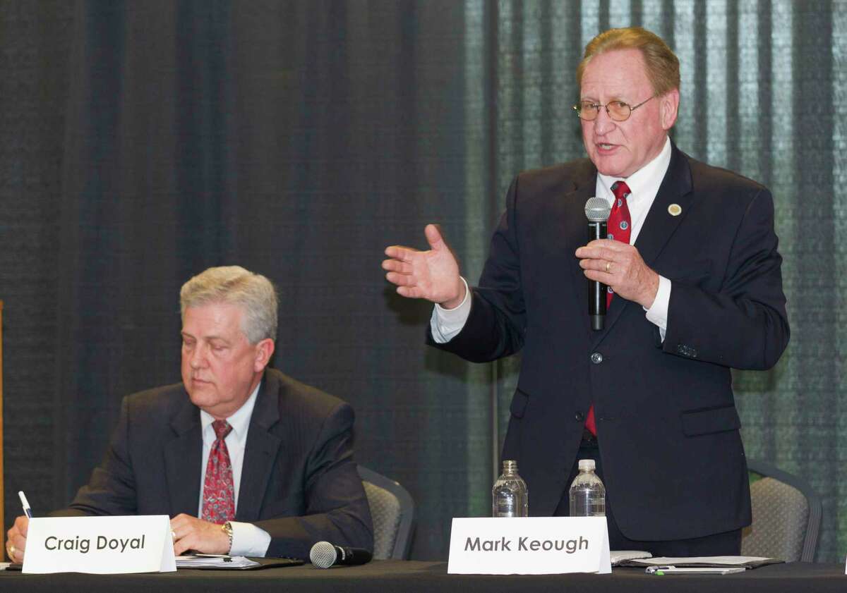 State Rep. Mark Keough, Republican candidate for Montgomery County Judge, speaks next to incumbent Craig Doyal during the Conroe/Lake Conroe Chamber of Commerce candidate forum at the Lone Star Convention & Expo Center, Tuesday, Feb. 6, 2018, in Conroe.